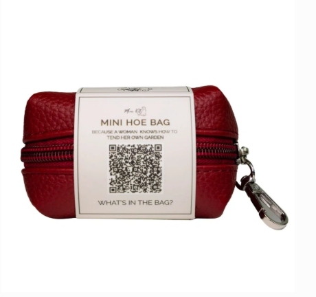 Back view of the Like A Kitten Mini Hoe Bag red travel pouch with zipper, clip, and branded wraparound label.