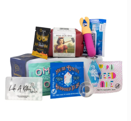Like A Kitten Mini Hoe Bag travel pleasure kit with rechargeable bullet vibrator, C-ring, lubricant, condoms, wipes, and personal care essentials.